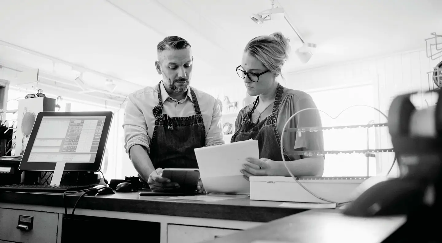 Business owners looking at tablet