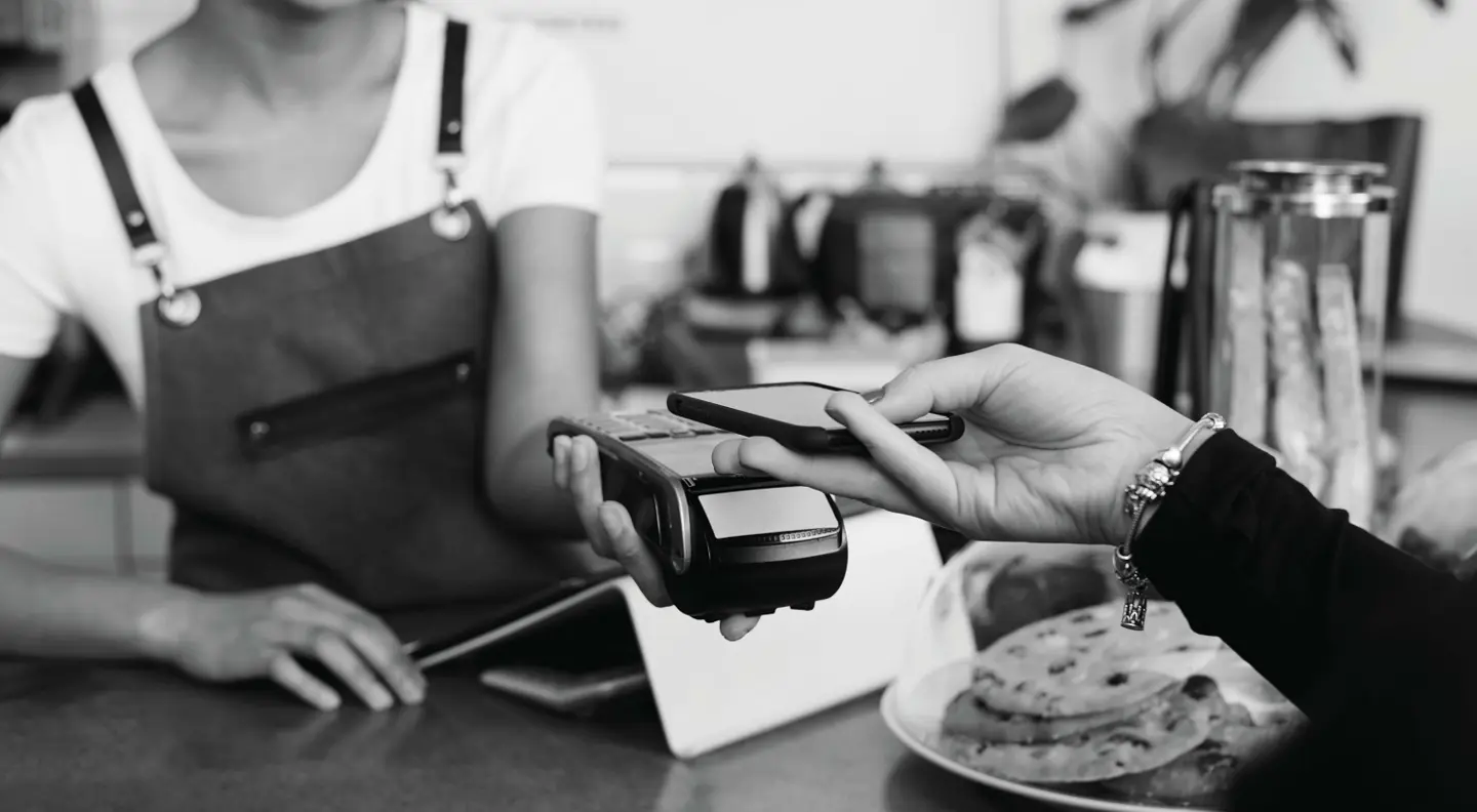 Person paying at shop using contactless